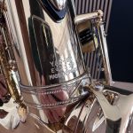Close-up of a highly polished chrome brass instrument with engraved 'MADE IN JAPAN' visible on the body