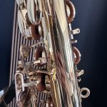 Close-up of shiny chrome metal parts with circular rings and curved bars against a dark background.